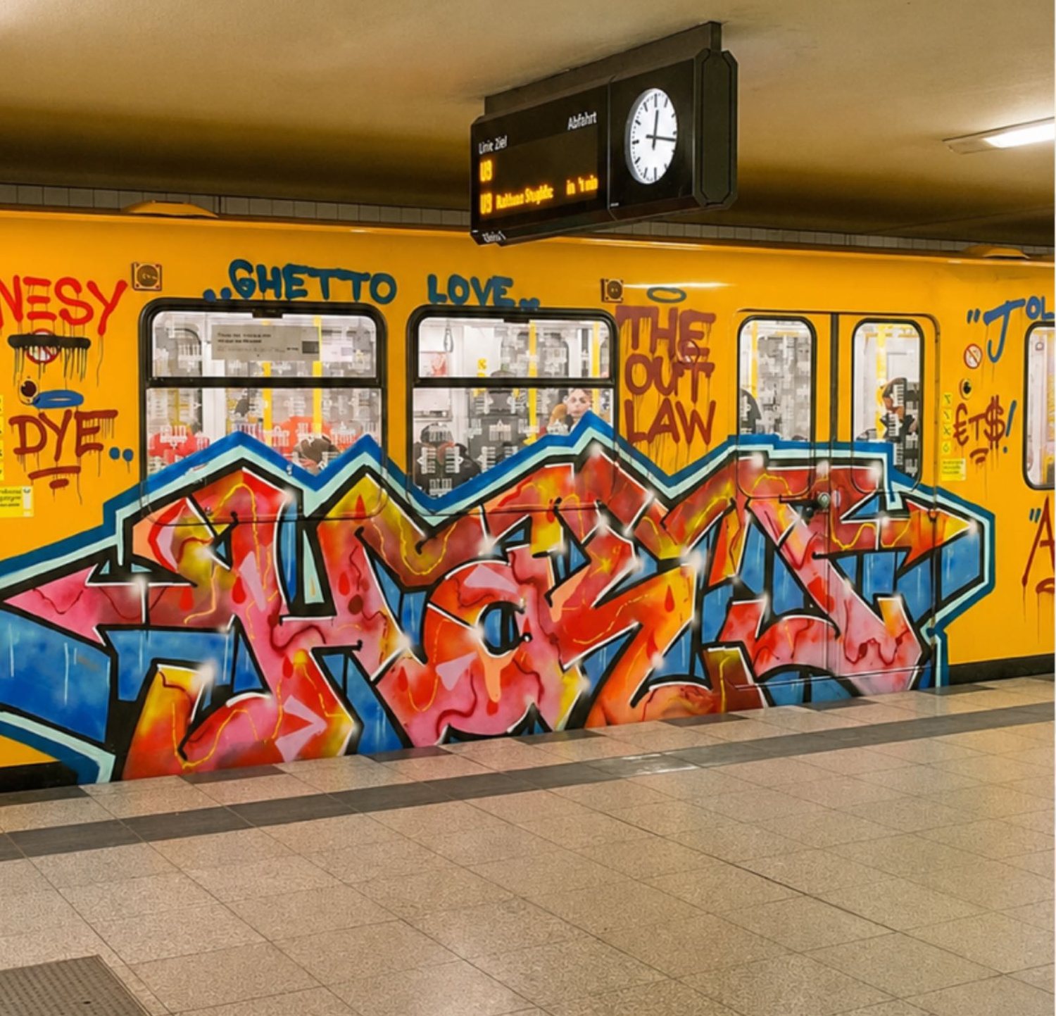 A sprayed yellow underground carriage in a Berlin station